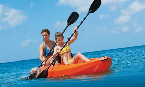 a mom and daughter kayak at a Dreams resort (c)Hyatt