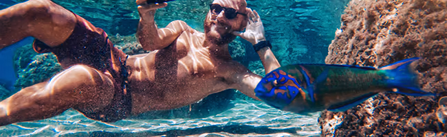 Young man taking selfie underwater