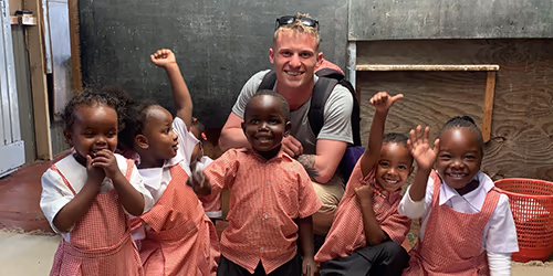 A man visiting kids in a Kenyan orphanage