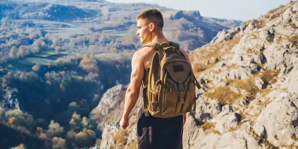 Shirtless young man at end of good hike