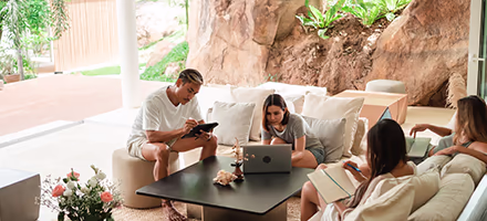 Young professionals collaborating in a luxury villa living room