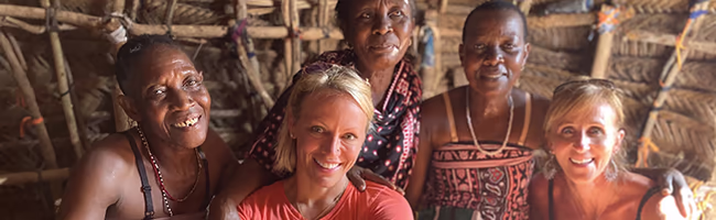 Two women sitting with Masaii ladies