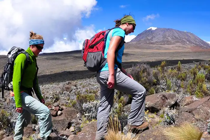 Two women hiking Mount Kilimanjaro