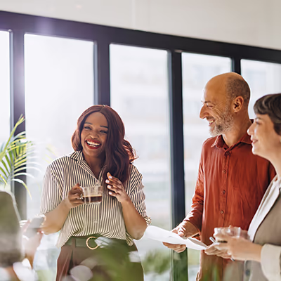 A woman drinking coffee in a circle of club members