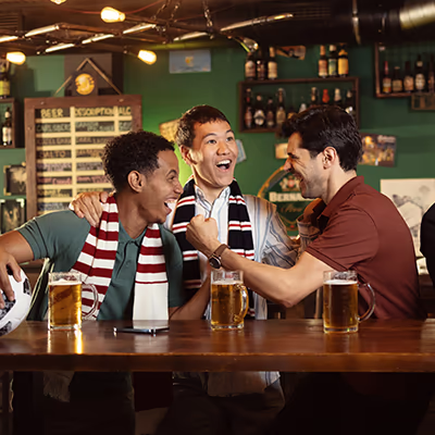 Three guys joke in a bar