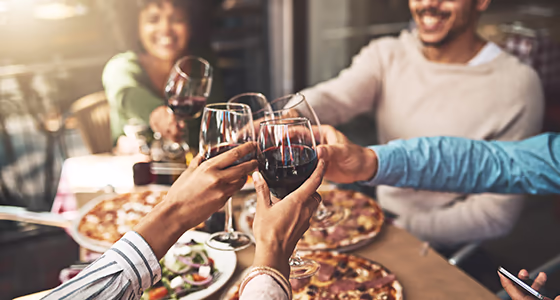 A wine club toasts their glasses