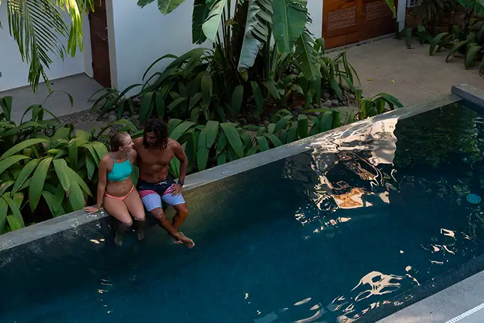 A couple sits together in a private pool
