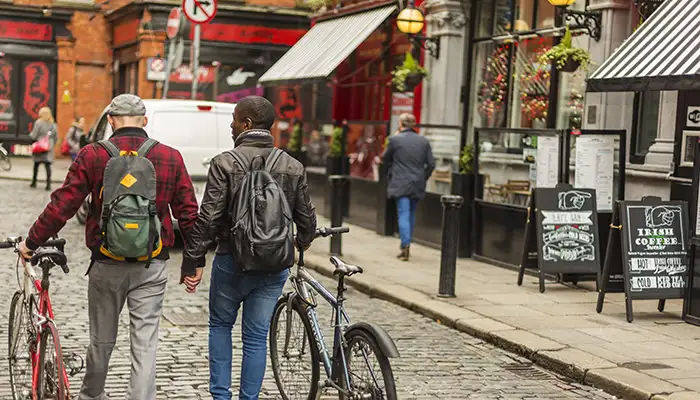 Two men hold hands in Dublin