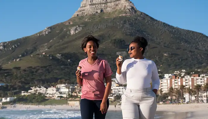 Two women enjoy ice cream in Cape Town, South Africa
