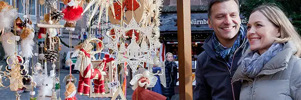 Couple looking at ornaments in a Christmas market
