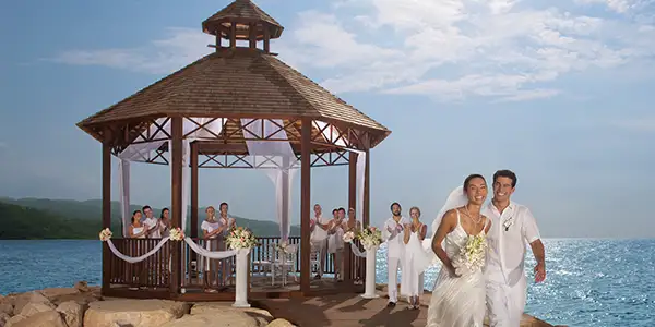 A wedding party in a gazebo overlooking the ocean